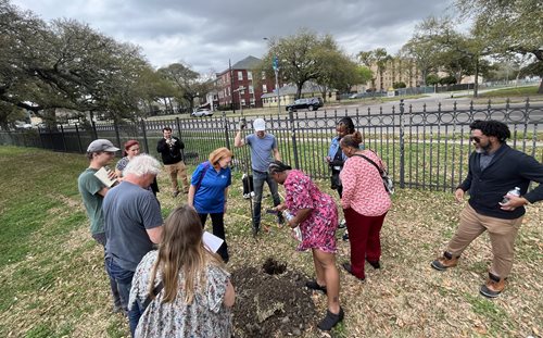 This picture shows a group of City Staff, Dillard University students and professors, and Deltares hydrologists inspecting the water levels during a groundwater well installation.