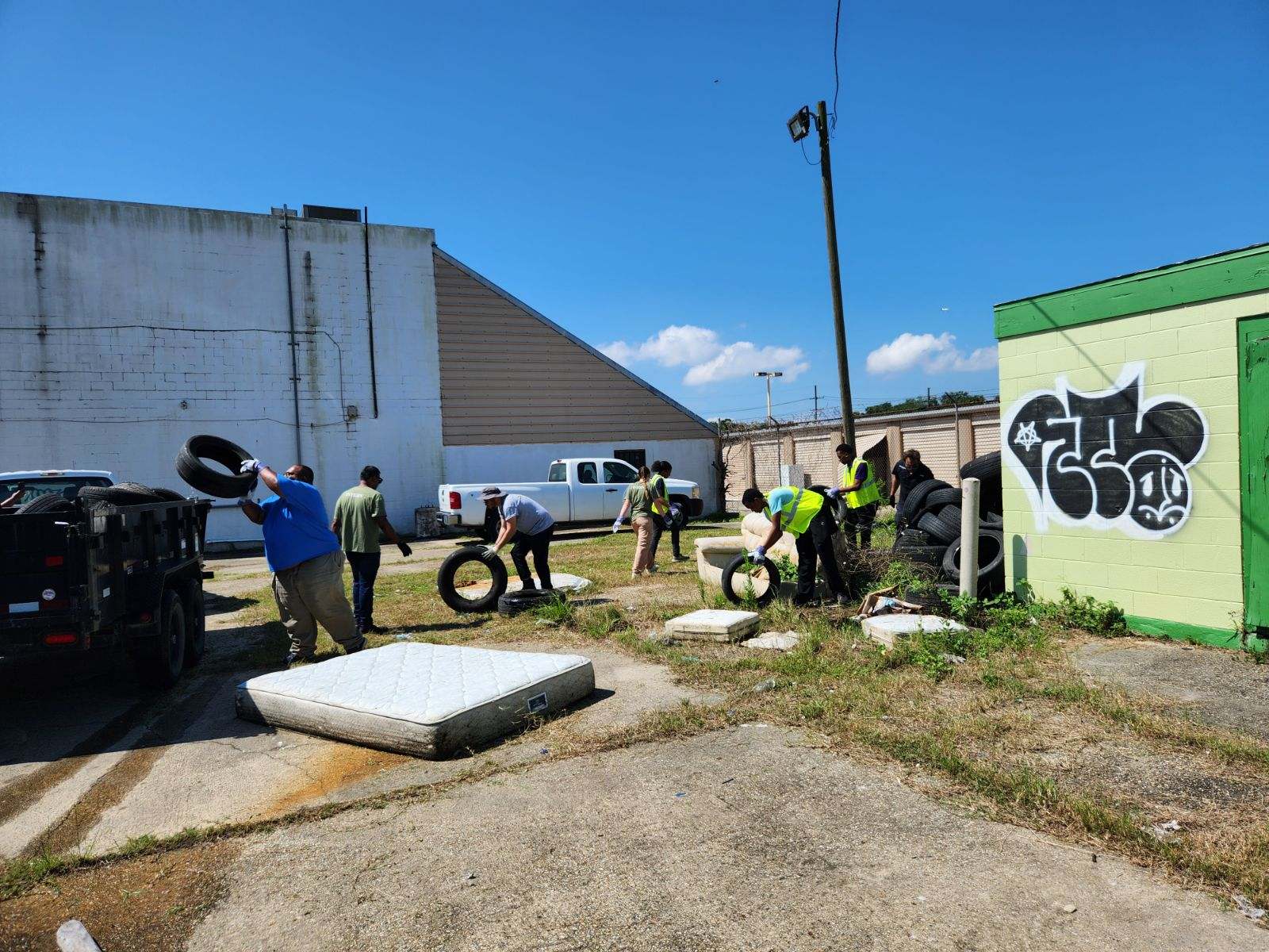 Community volunteers removing discarded tires